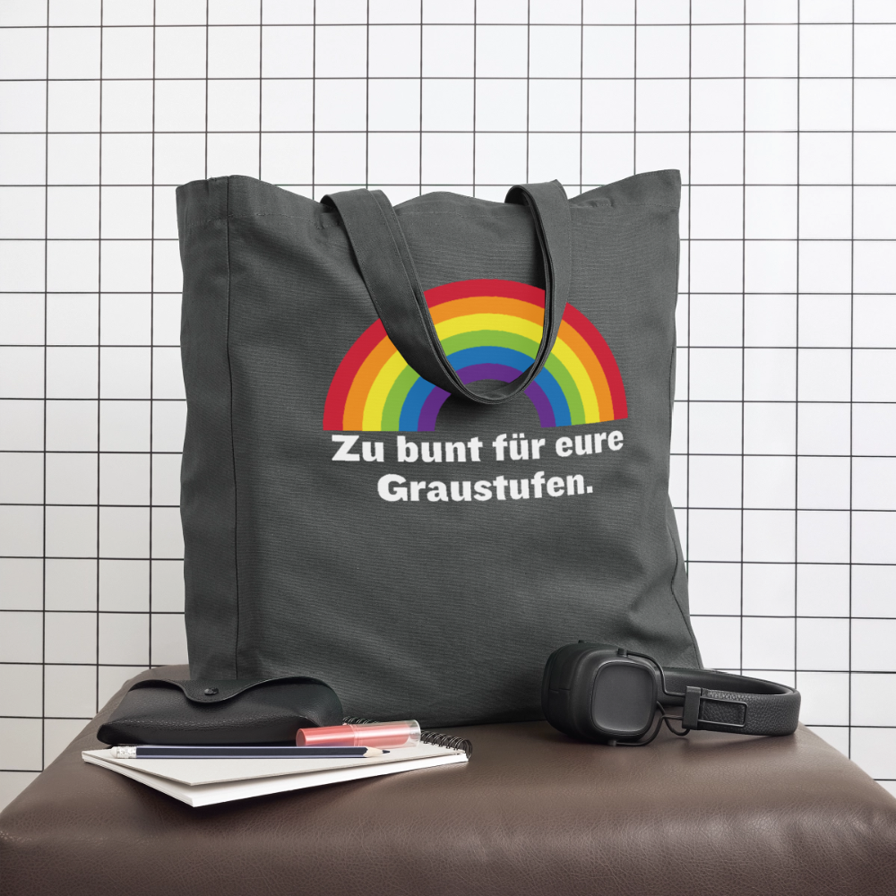 Moderne dunkelgraue Tote Bag auf einem Sitzhocker im Studio, perfekt als robuster Begleiter im Alltag